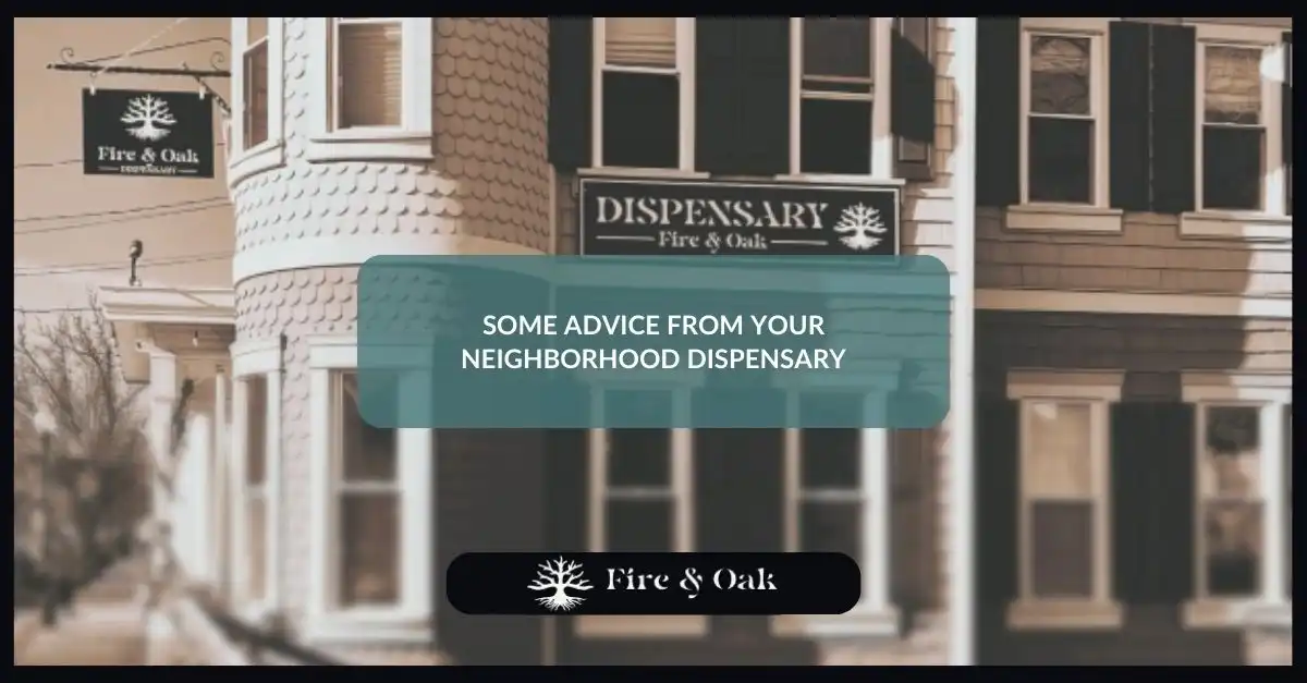 Exterior view of Fire & Oak dispensary with a sign displaying "Dispensary" and the business name, featuring a message offering advice from the neighborhood dispensary.