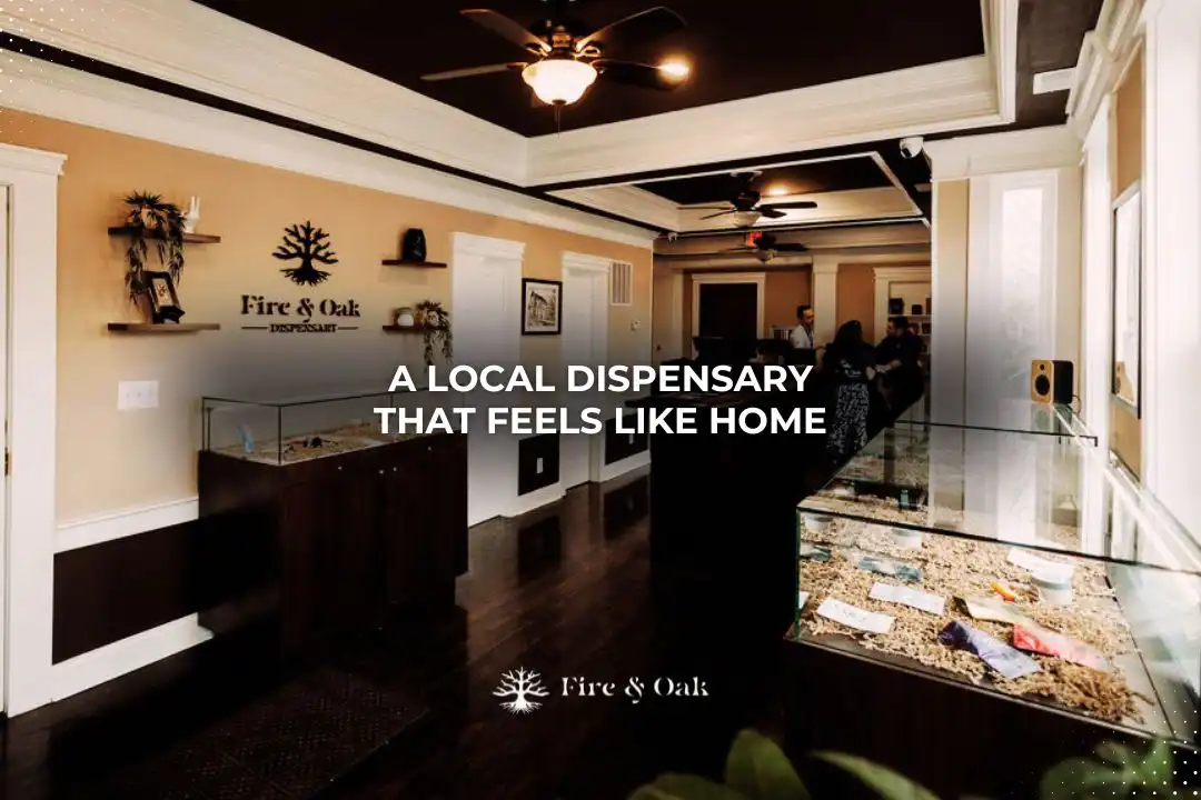Interior view of Fire & Oak dispensary, showcasing a welcoming atmosphere with wooden display cases and a cozy design, emphasizing a local, home-like experience for customers.
